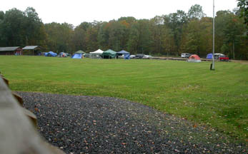 Photo by Ray Kaville
Looking out from the porch of the lodge building a few tents are set up in the rain.
